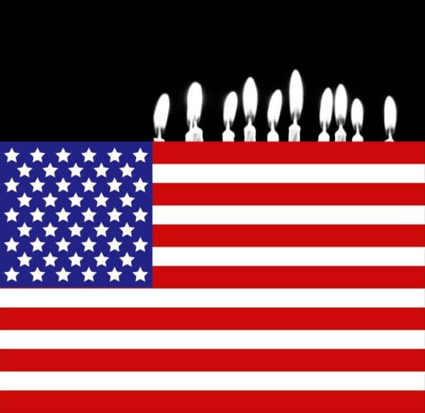 Happy Birth, Death, Rebirth Day America! U.S. Flag with birthday candles at the top edge against a black background. ∴ WholeSpirit